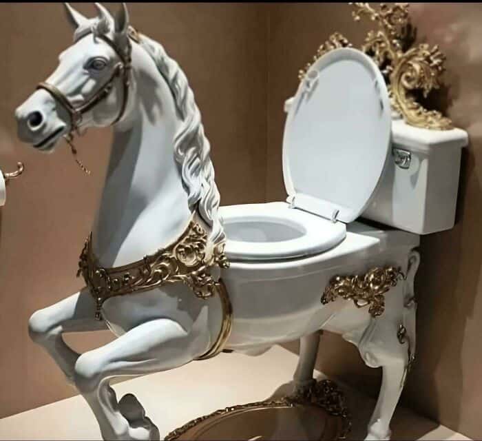 Ornate horse-shaped toilet with gold accents and a white seat.