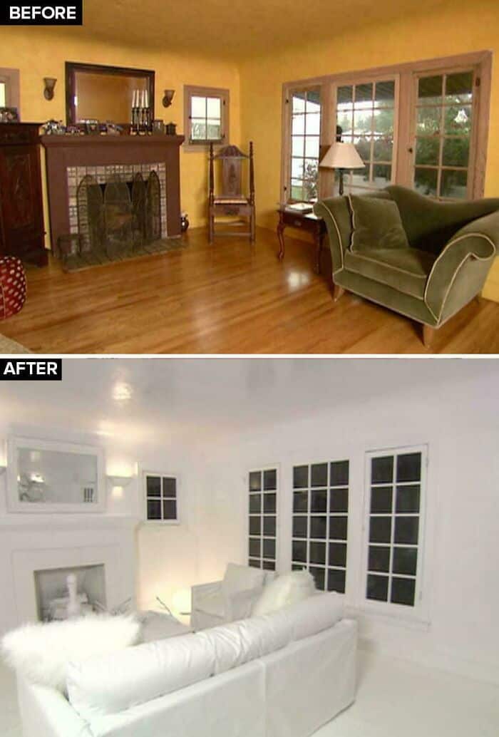 Brightened living room with white furniture and large windows after renovation.
