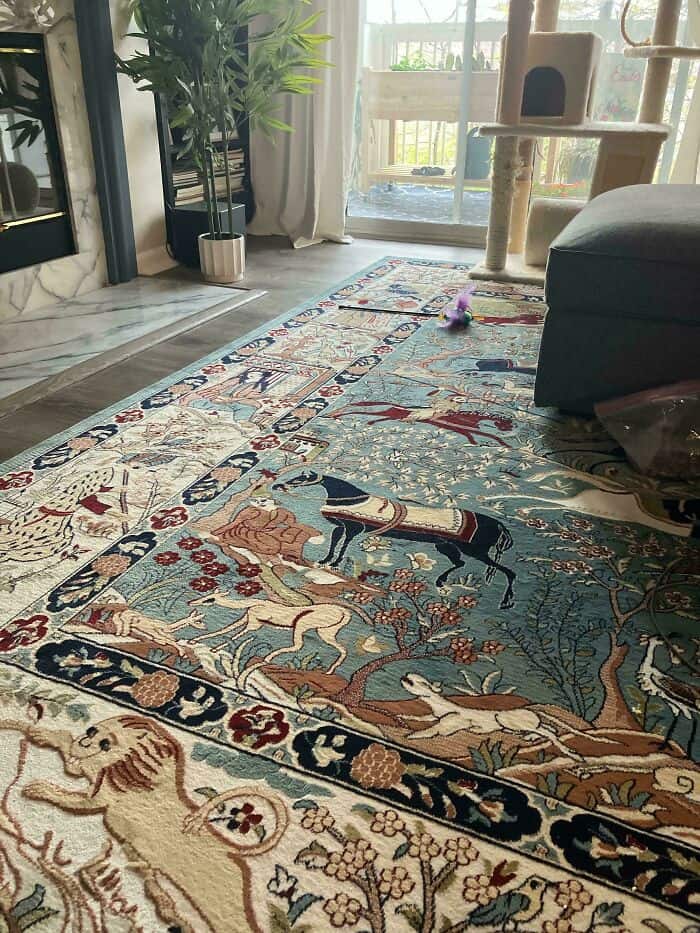 Beautiful Persian-style rug with intricate patterns and animal motifs in a cozy living room.