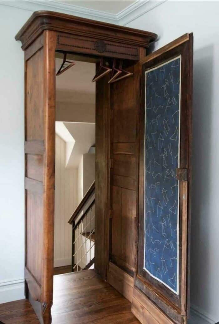 Antique wooden wardrobe with a chalkboard door and hanging space inside.