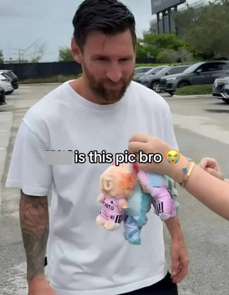 Man with beard in white shirt holding colorful plush toy, caption says 'is this pic bro'.