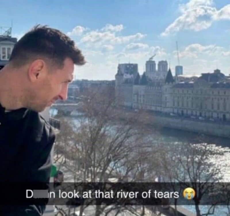Man looking at river of tears with cityscape background.