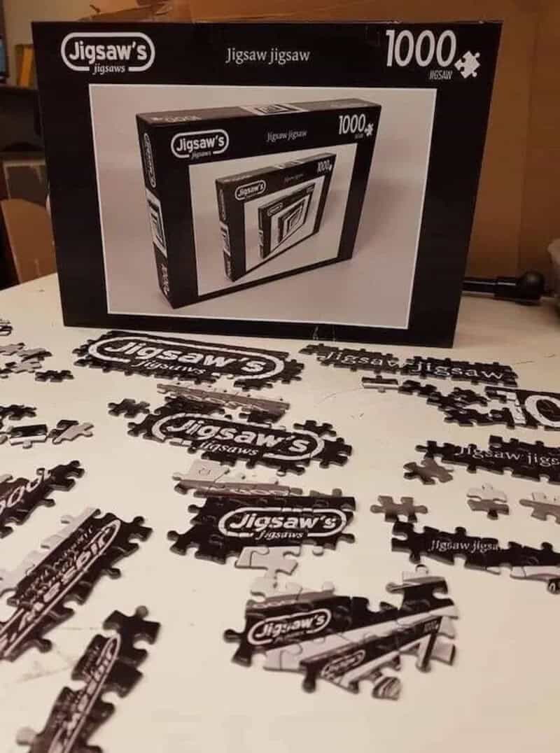 Jigsaw puzzle box and assembled puzzle pieces with "Jigsaw" branding on the pieces.