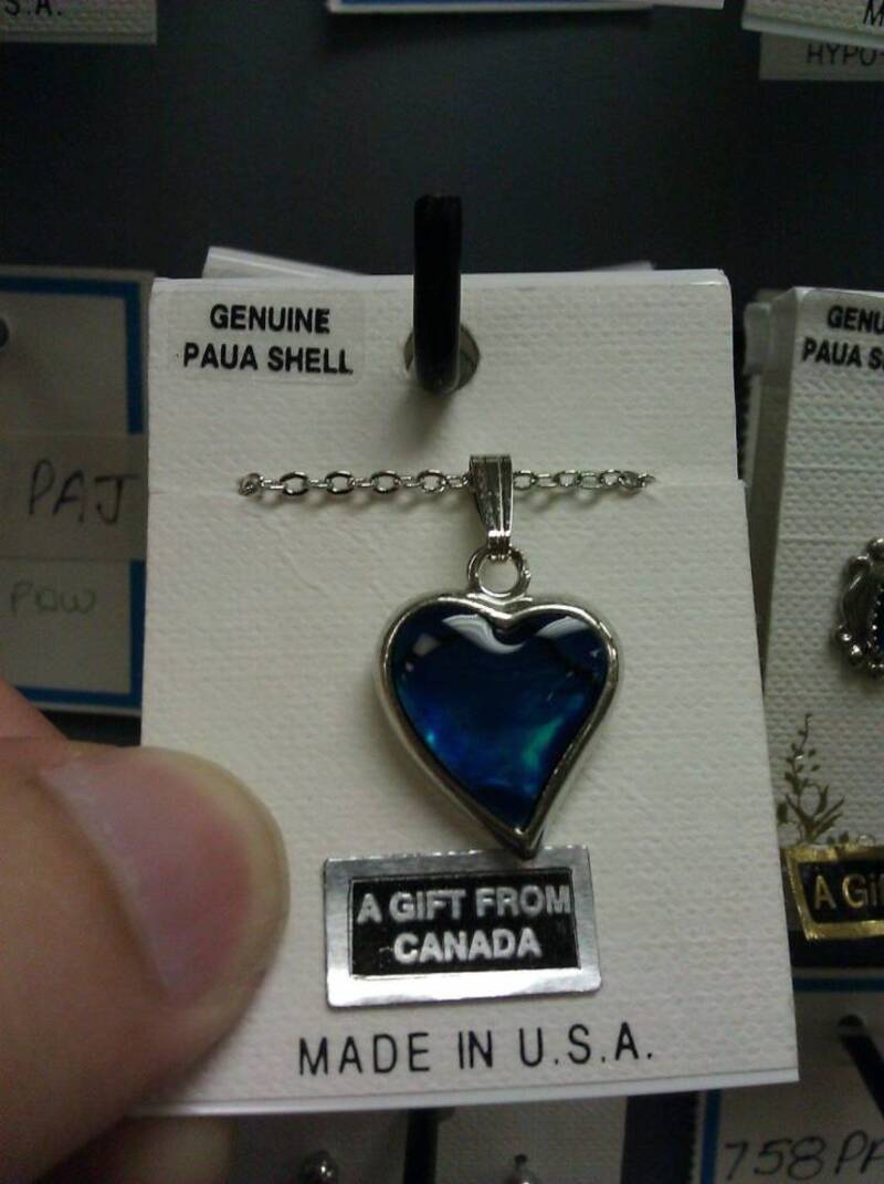 Genuine Paua Shell heart pendant with "A GIFT FROM CANADA" tag, made in U.S.A. on display.