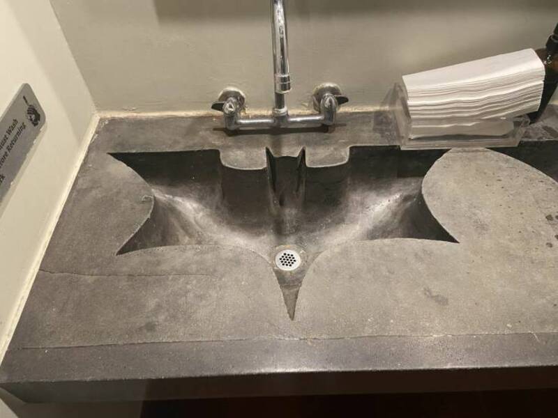 Sink with a unique star-shaped basin and a faucet above it.