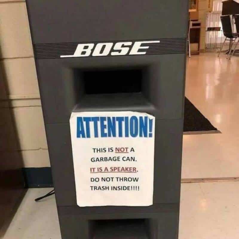 Bose speaker disguised as a garbage can with a sign warning not to throw trash inside.