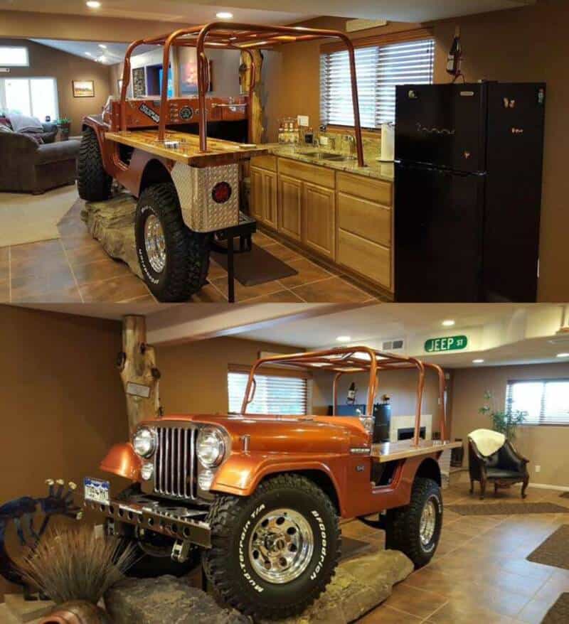 Vintage Jeep wagon inside a home, converted into a kitchen and display area.
