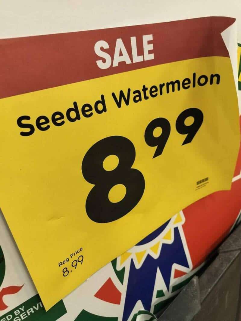 Seeded Watermelon SALE sign, price $8.99, yellow and red background, bold black text.