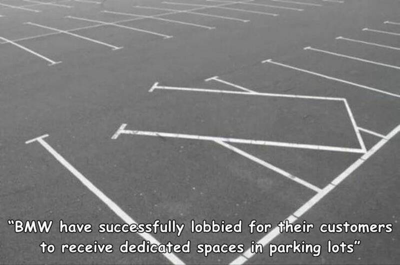 BMW parking lot with empty spaces and a caption about successful lobbying for dedicated parking spac.
