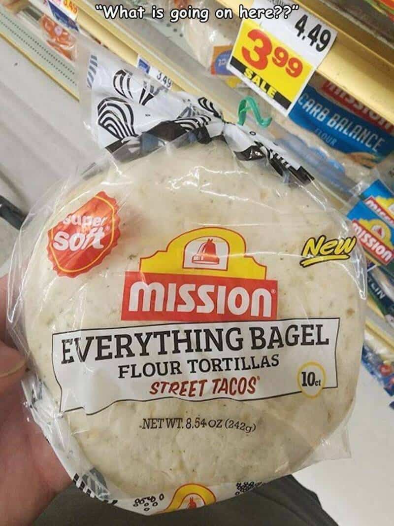 "Mission Everything Bagel Flour Tortillas" package with a price tag of $3.99, held in a person's han.