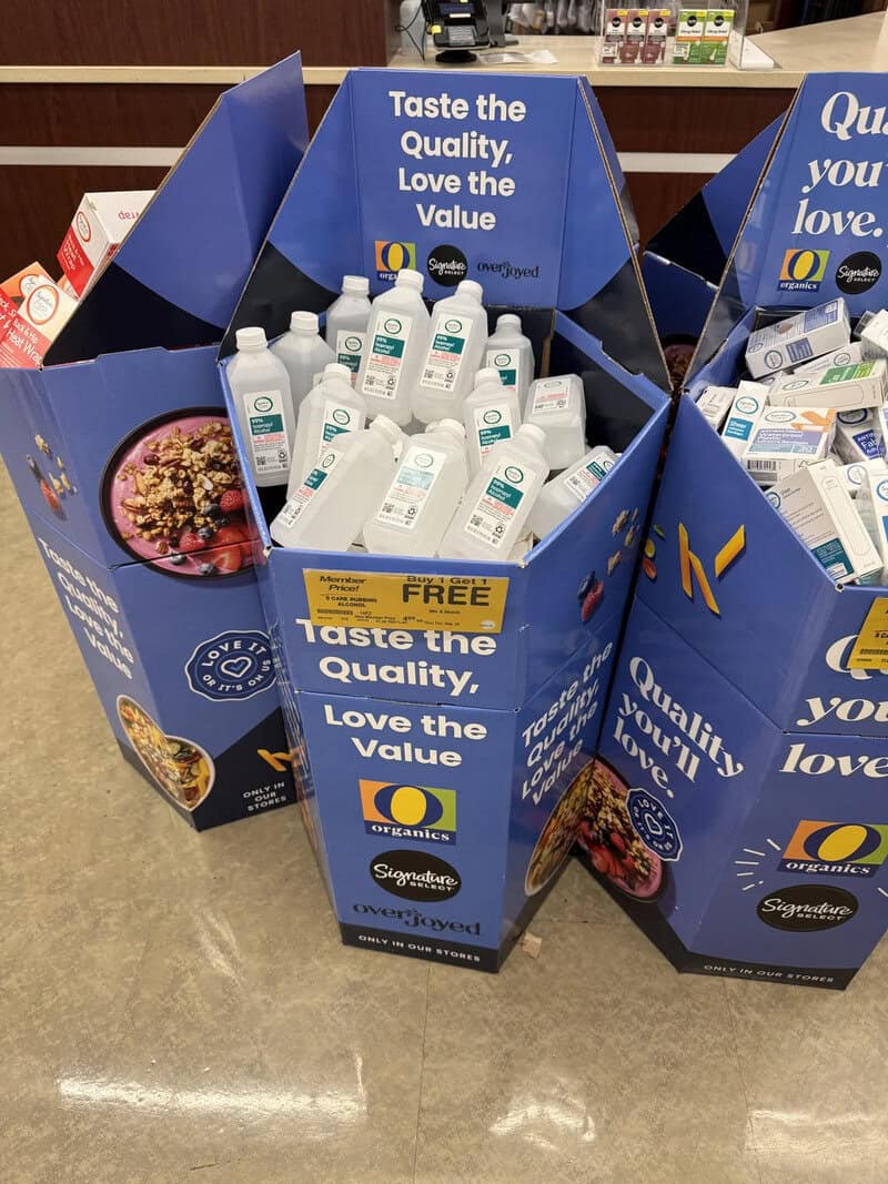 "Organic hand sanitizer bottles in a blue display box at a store".