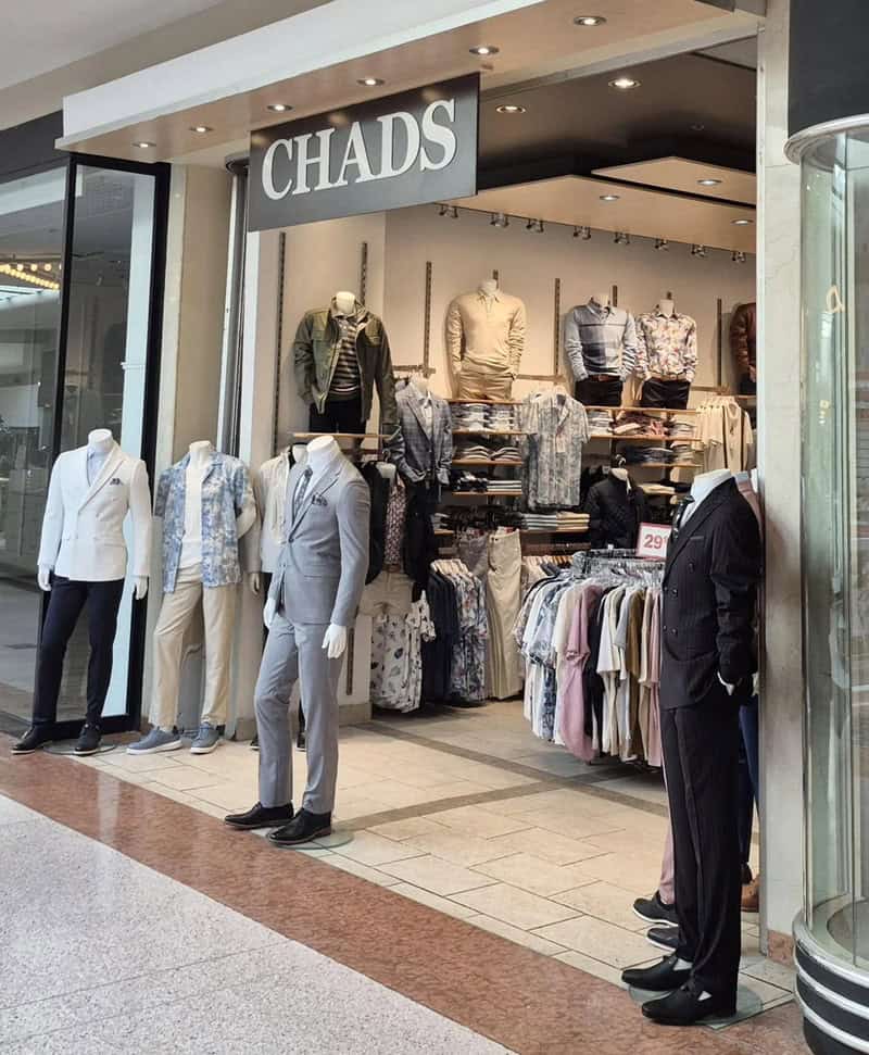 Men's clothing store "CHADS" with mannequins displaying suits and casual wear.