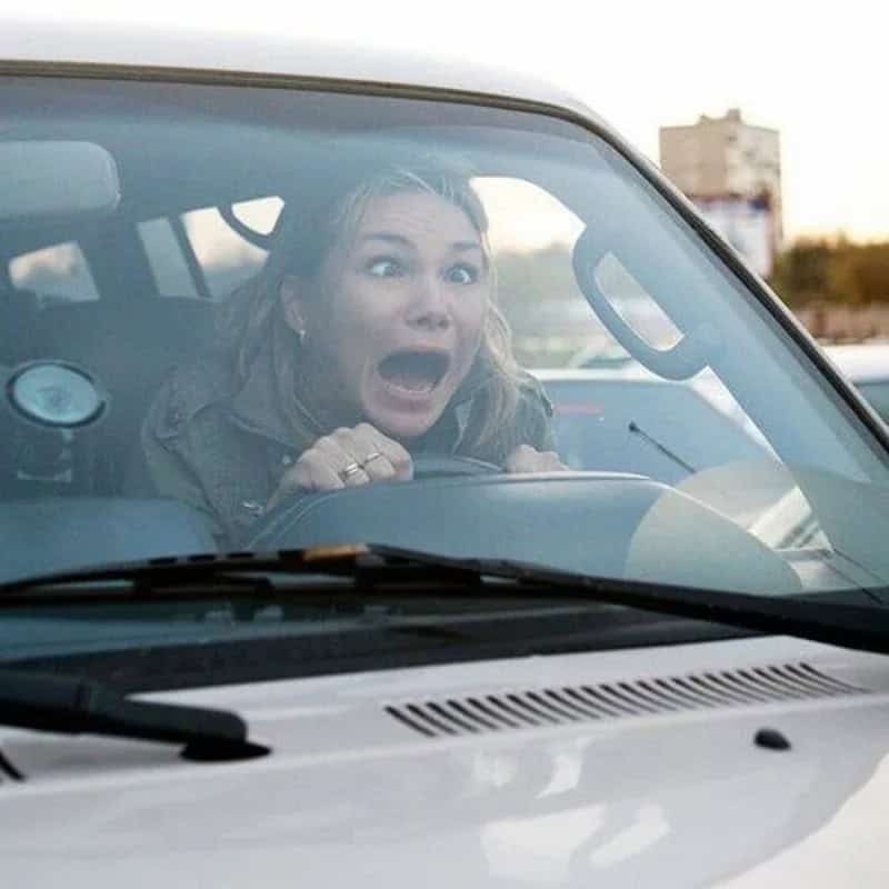 Woman with surprised expression driving a car, from the 'funny pictures' post.