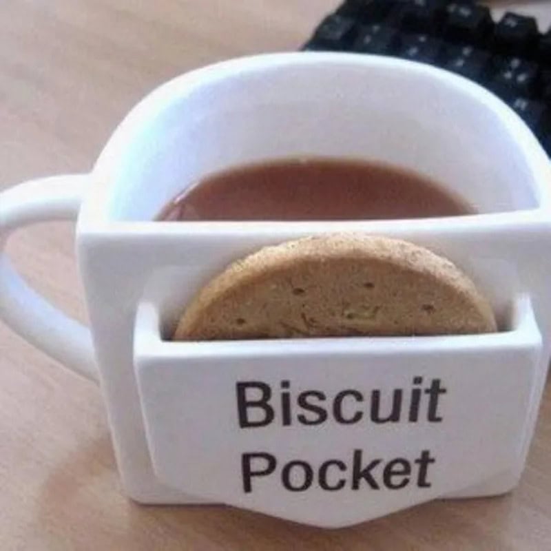 Mug with a cookie in a pocket labeled 'Biscuit Pocket'.