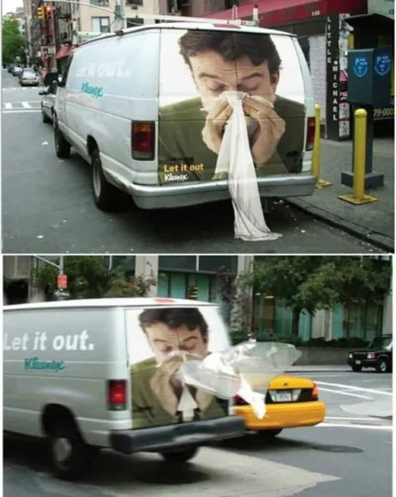 Van with a large image of a man sneezing into a tissue, with the text "Let it out" and "Kleenex".