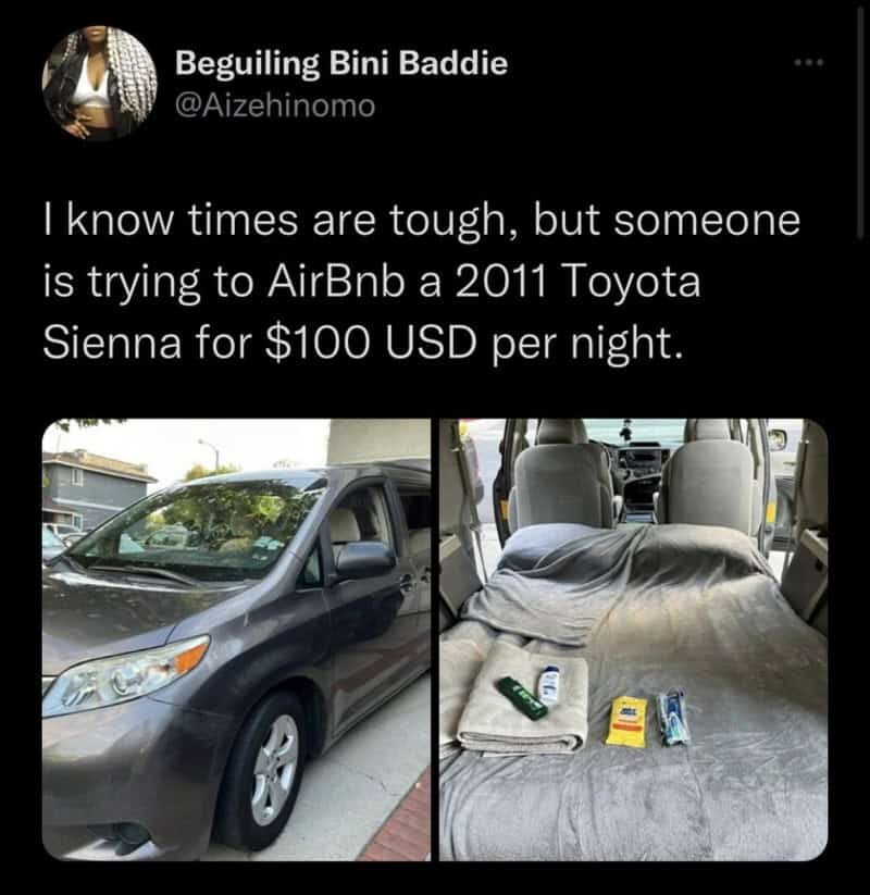 Photo of a gray Toyota Sienna with a makeshift bed inside, parked outside.