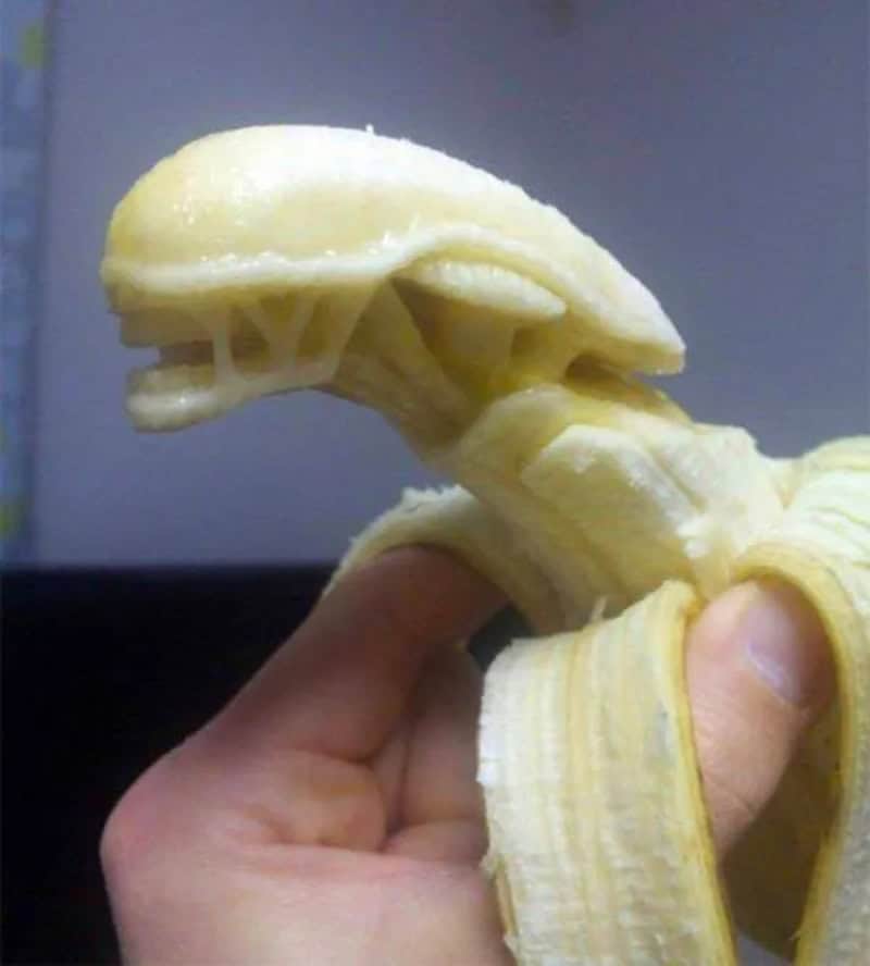 Banana peeled to resemble a dinosaur head with open mouth.