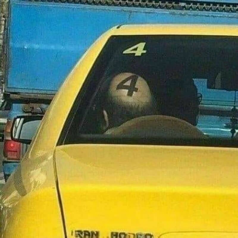 Car with a sticker of the number 4 on the rear window and a person with a 4 on their head.