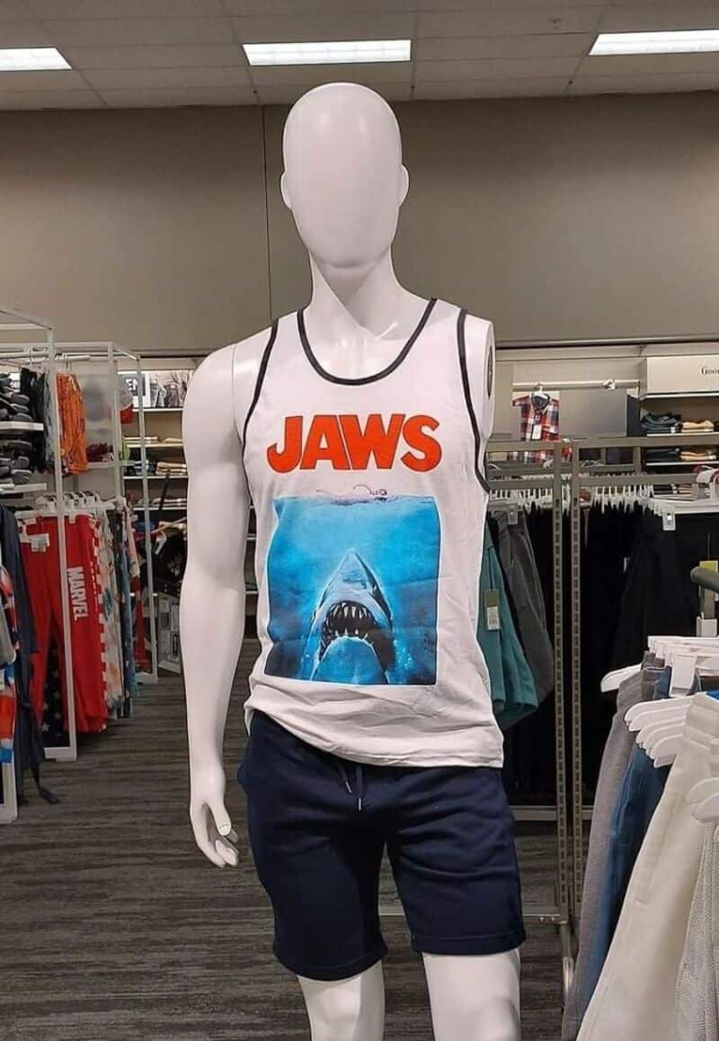 Mannequin wearing JAWS tank top and navy shorts in store.