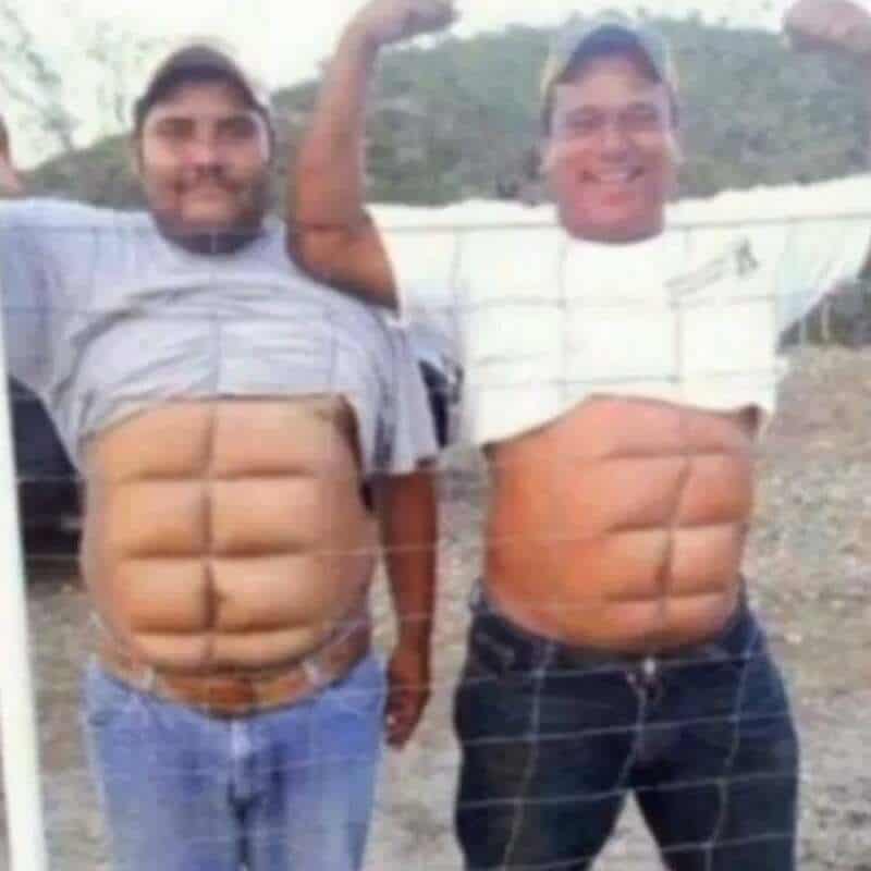 Two men with photos of abs on their stomachs, lifting their shirts to show the images.