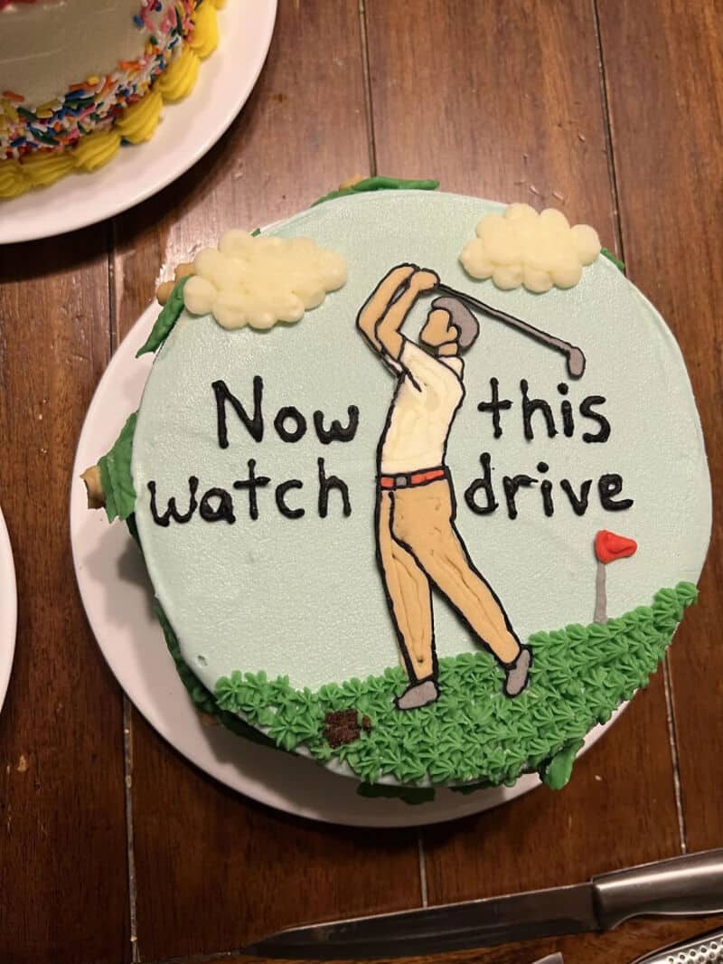 Cake with a golfer and the words 'Now this watch drive'.