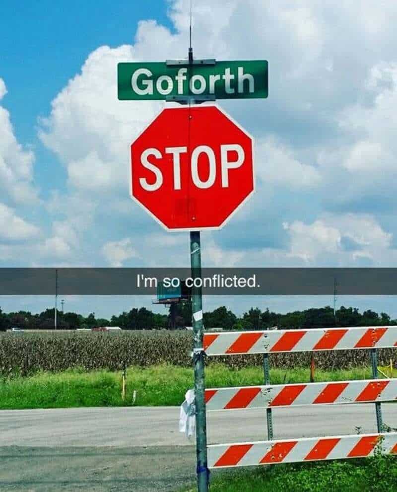 Goforth street sign above a stop sign with a barrier in front, saying 'I'm so conflicted.'.