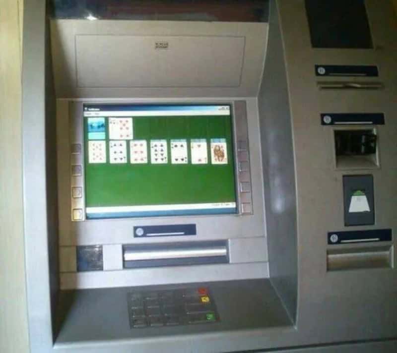 ATM machine with a computer screen showing a game of Solitaire.
