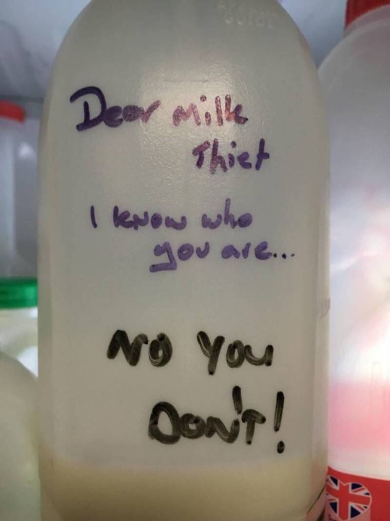 A milk bottle with a handwritten note saying 'Dear milk Thiet I know who you are... NO you don't!'.