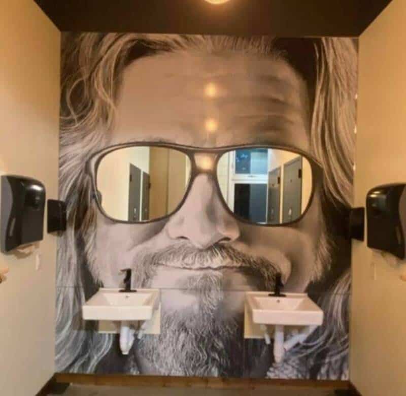 Wall mural of a man with sunglasses and long hair, with sinks in front of his face.