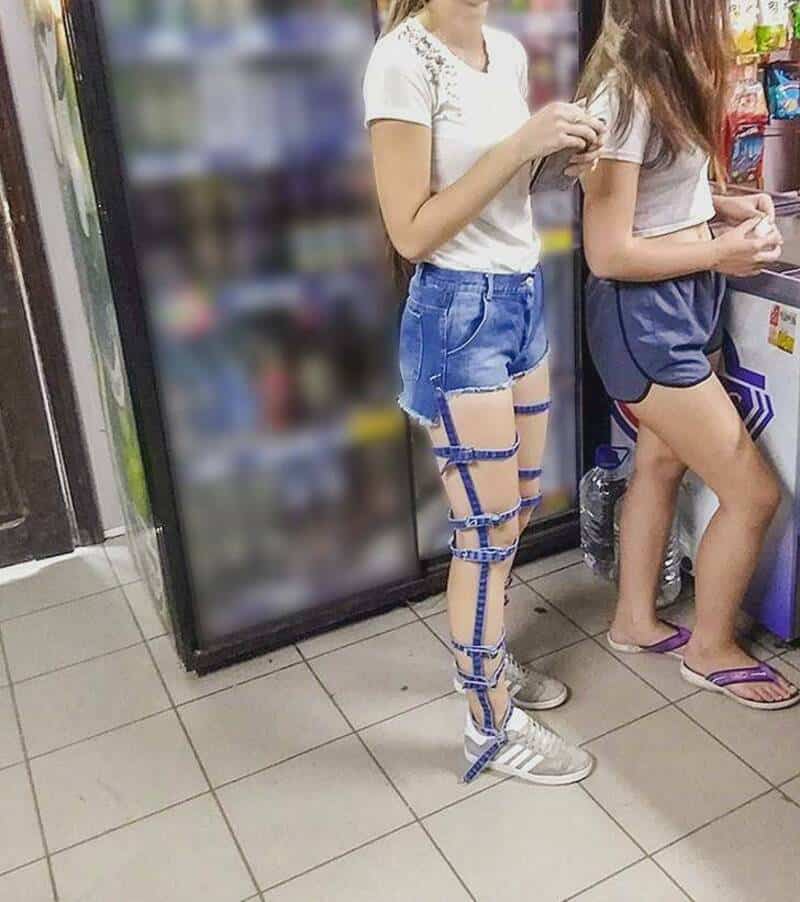 Two girls in casual clothes with one wearing a leg harness in a store.