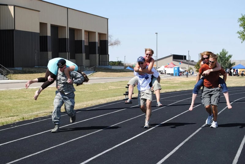 Kids participating in a fun relay race on a track at school or sports event.