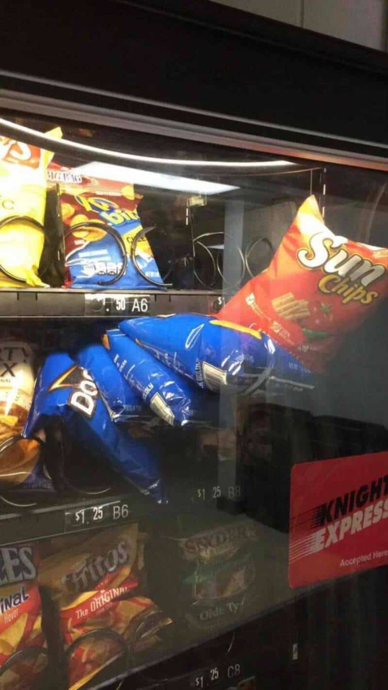 Aisle of snack chips in a vending machine with Sun Chips and Doritos brands.