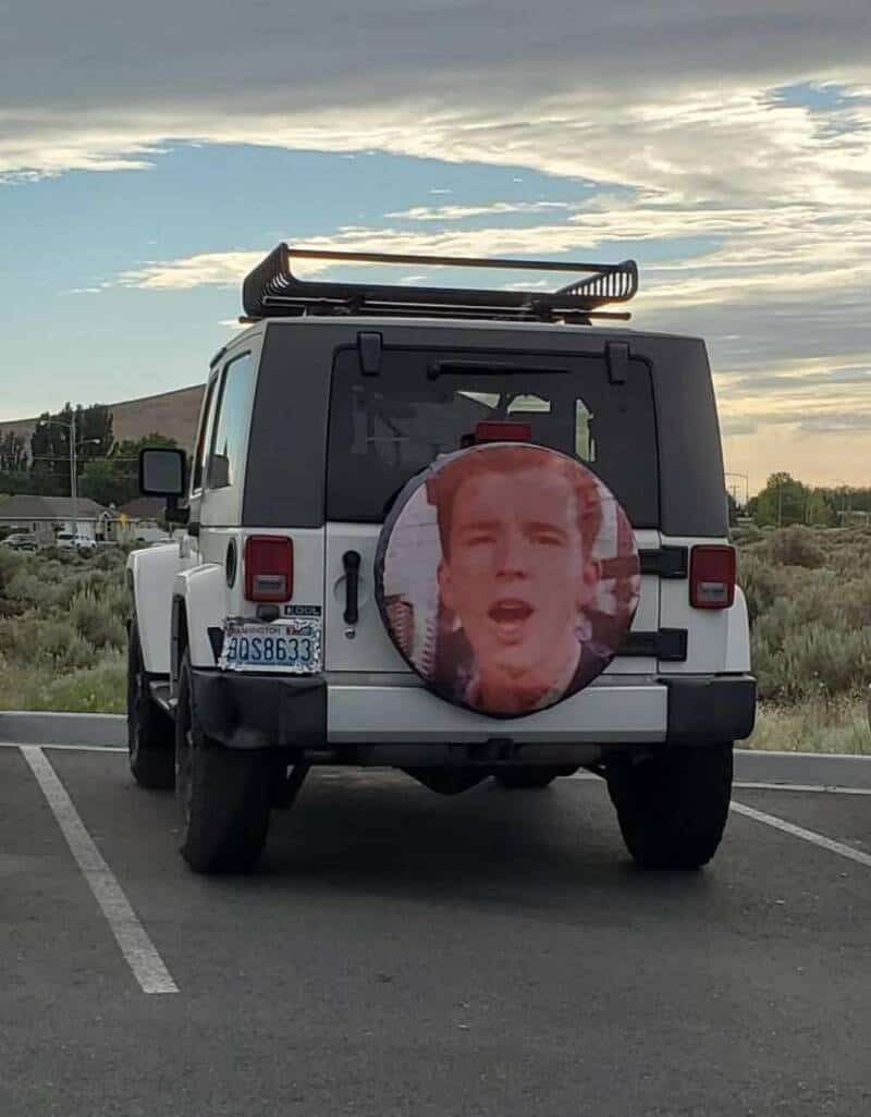 Jeep with a large circular image of a person's face on the back door.
