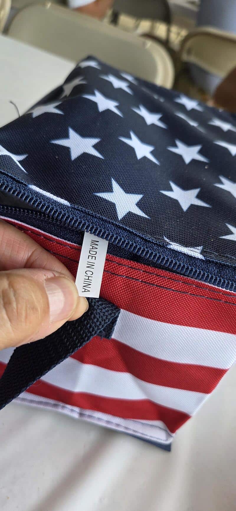 American flag-themed fabric bag with a "Made in China" tag, featuring stars and stripes design.
