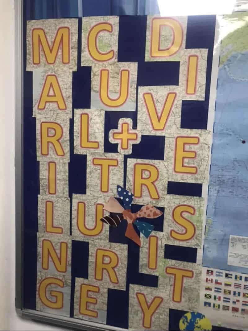 Sign with large yellow letters spelling 'MARCHING' and 'CULTURE' with a butterfly decoration.