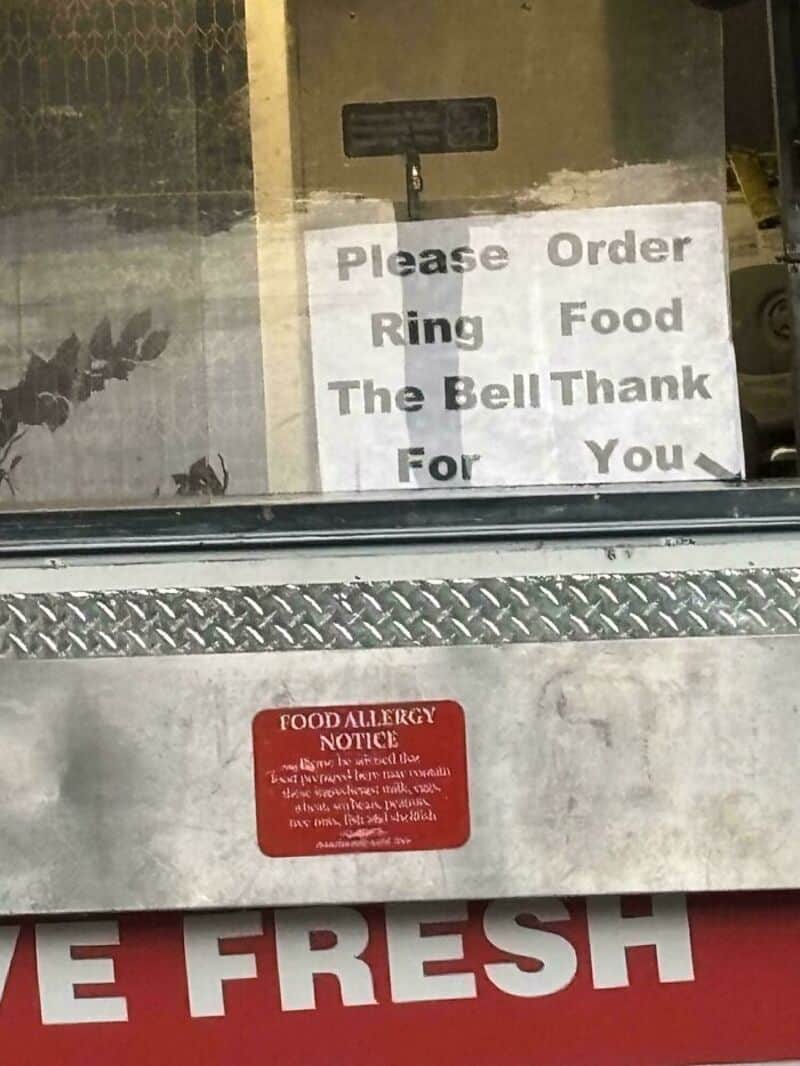 Sign requesting customers to ring the bell to order food, with a food allergy notice below.