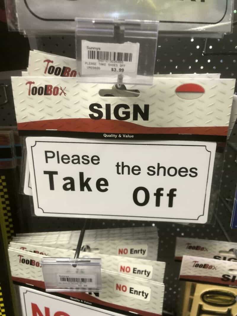 Sign says 'Please Take Off the shoes' with 'Take' misspelled as 'Tack'.