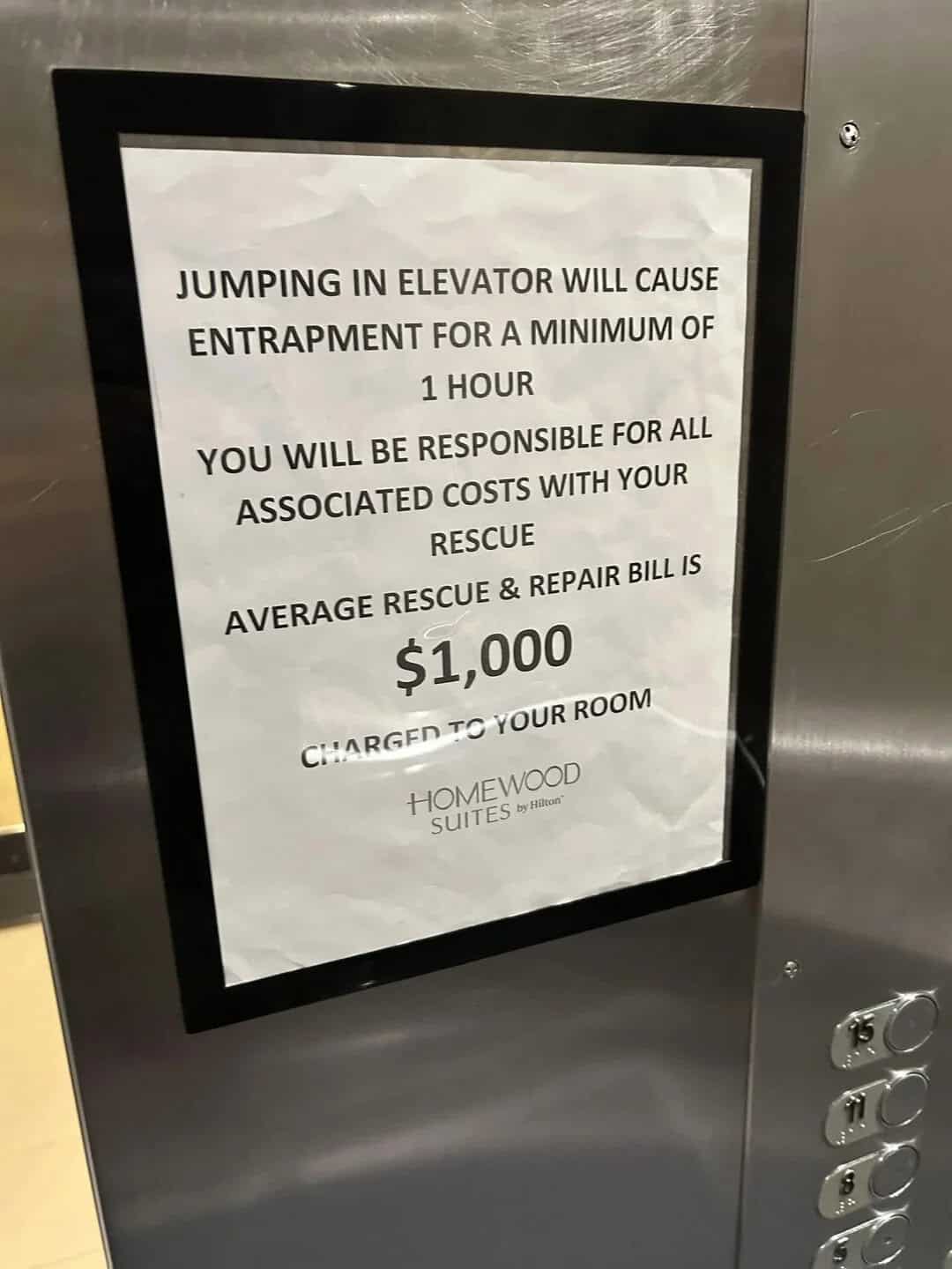 Sign warning about jumping in elevator causing entrapment and costs.