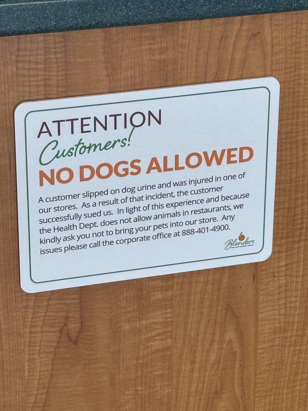 Sign says no dogs allowed, explains incident of a customer slipping on dog urine.
