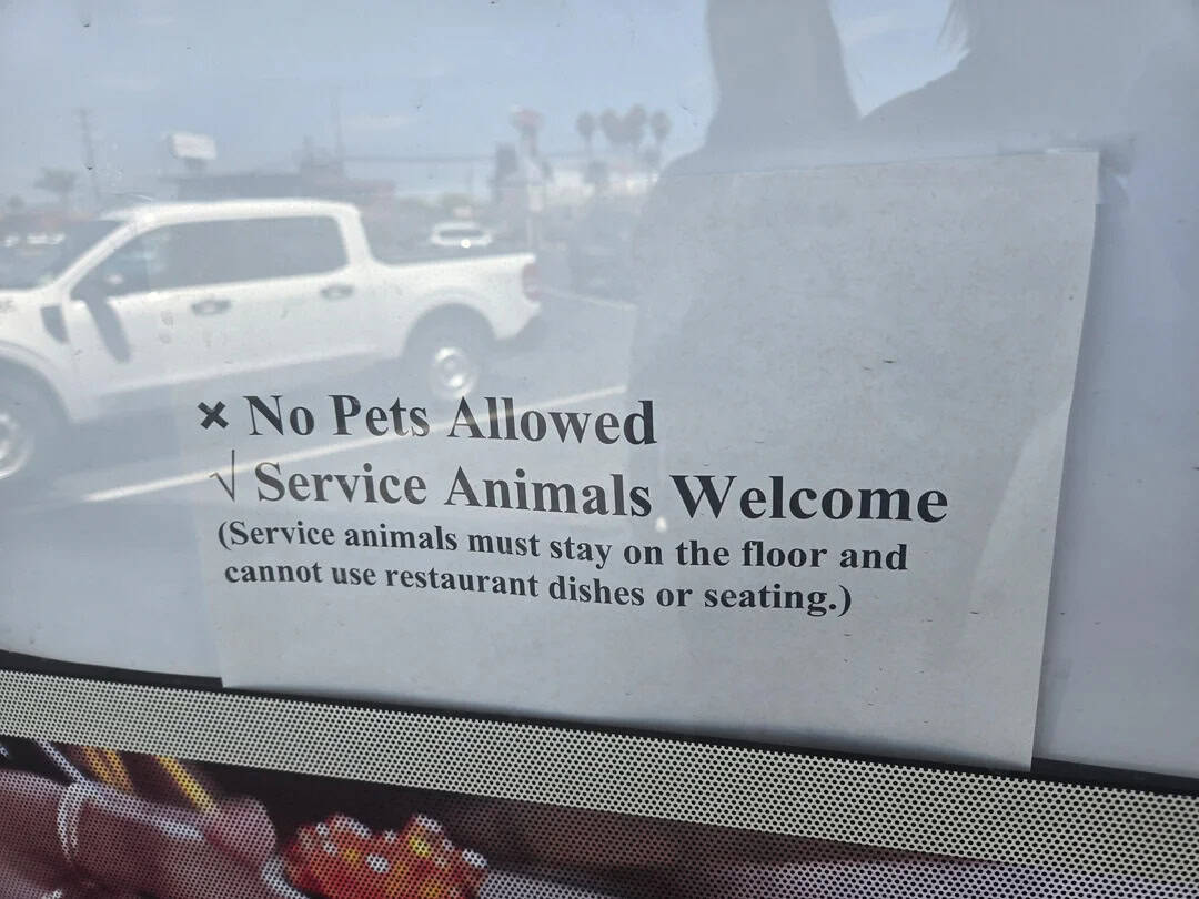 No Pets Allowed, Service Animals Welcome sign with additional info.