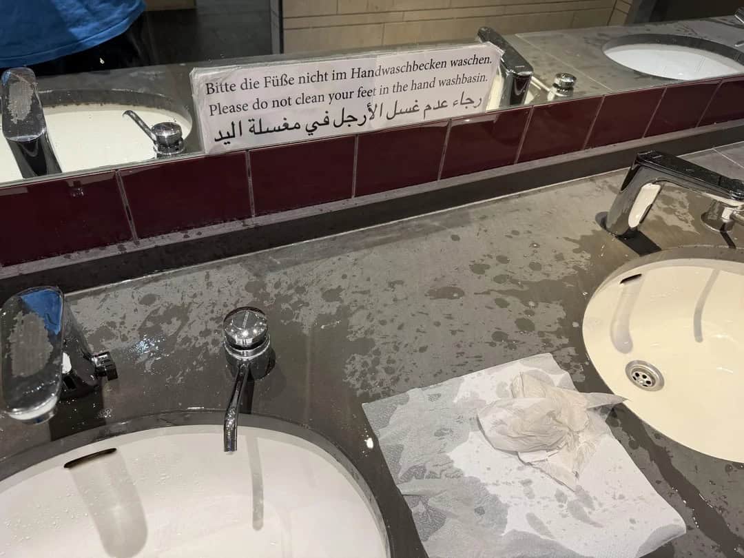 Sign in bathroom warns not to wash feet in hand wash basin.