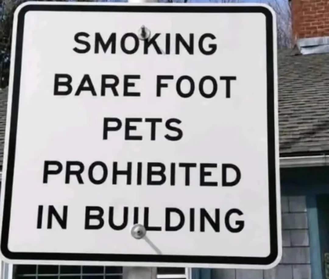 Sign says smoking, bare foot, pets prohibited in building.