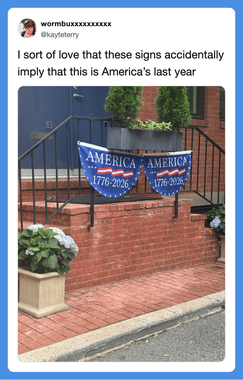 "America 1776-2026 signs hanging on a porch railing".