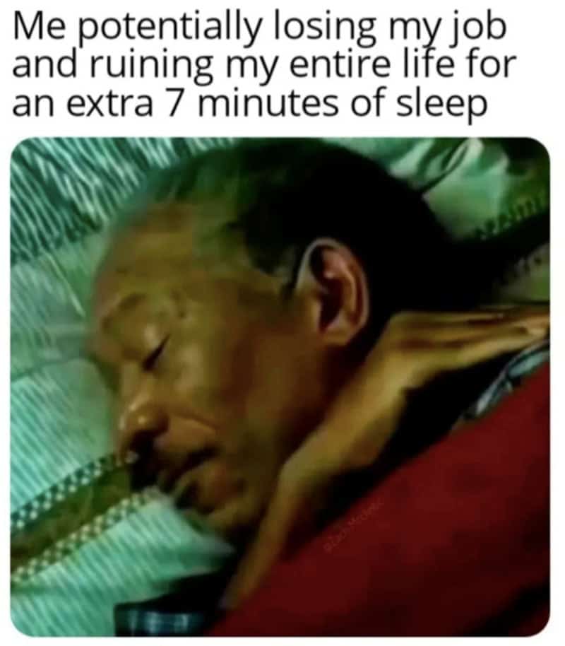 Man sleeping with a humorous caption about losing his job for 7 extra minutes of sleep.