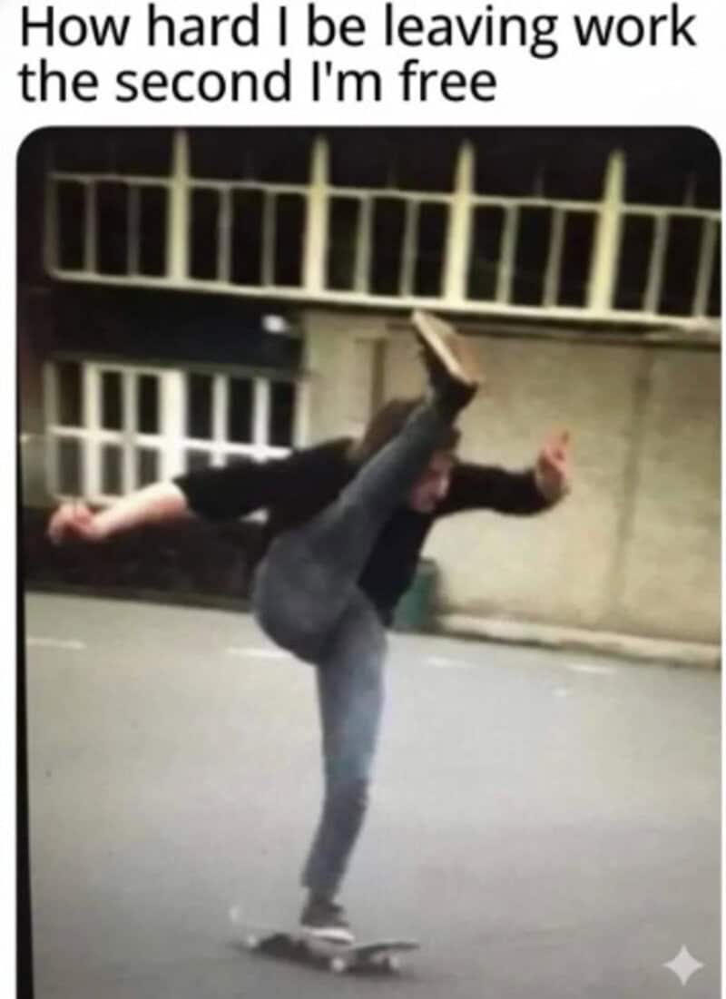 Leaving work behind, person performs a skateboarding trick on the street at night.