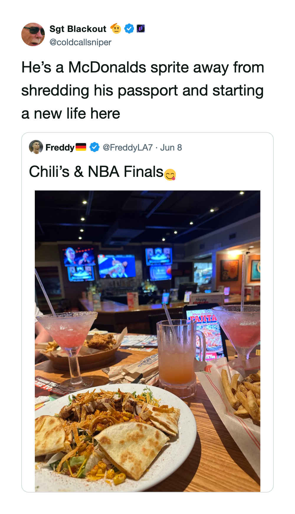 Image of a restaurant with drinks and food, TV screens showing sports, and a lively atmosphere.