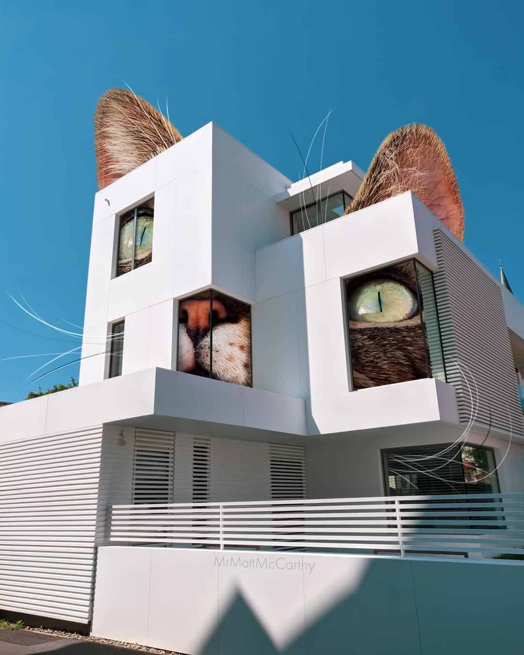Modern building with large cat face murals on the exterior walls.