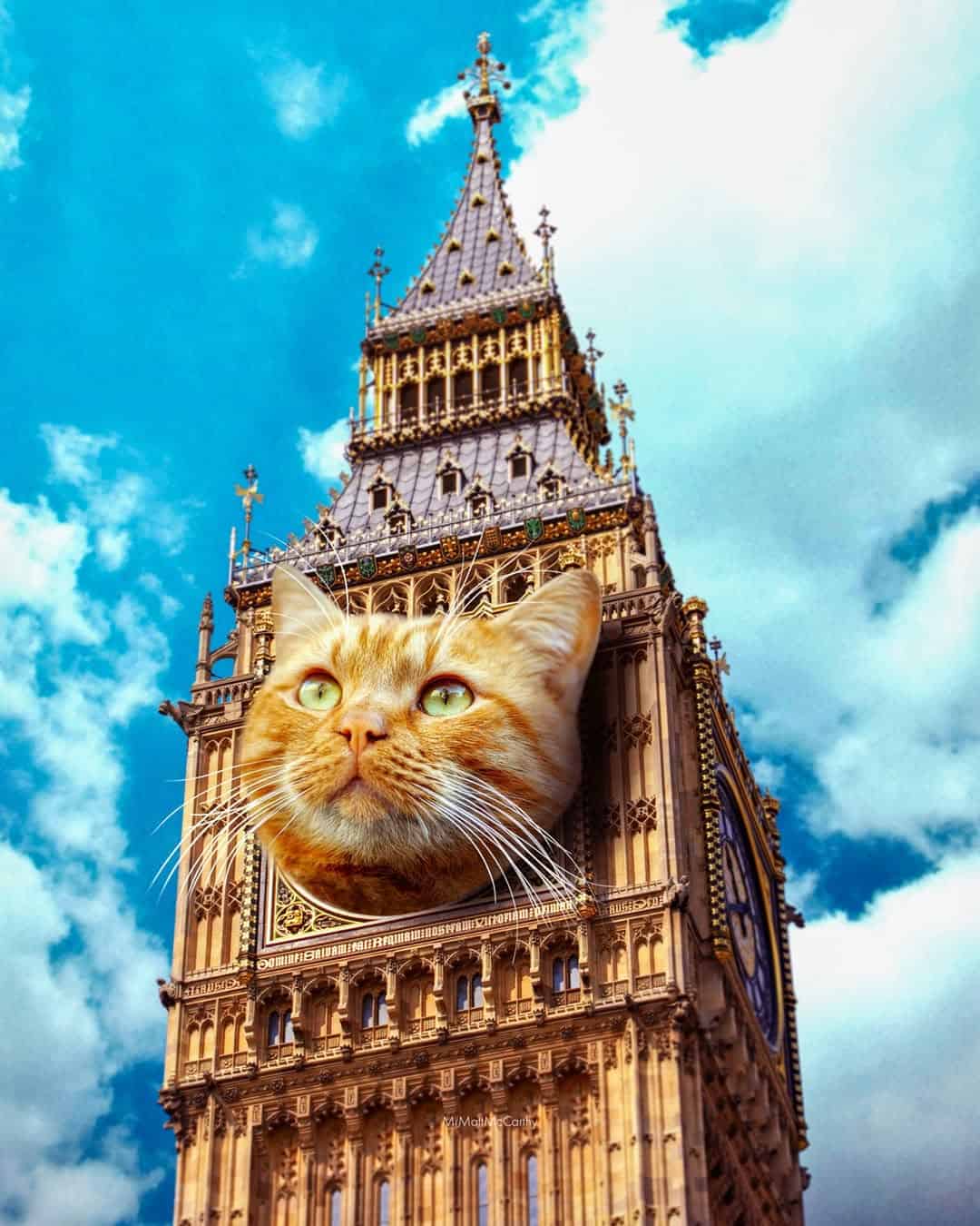 Giant cat face on Big Ben clock tower against blue sky with clouds.
