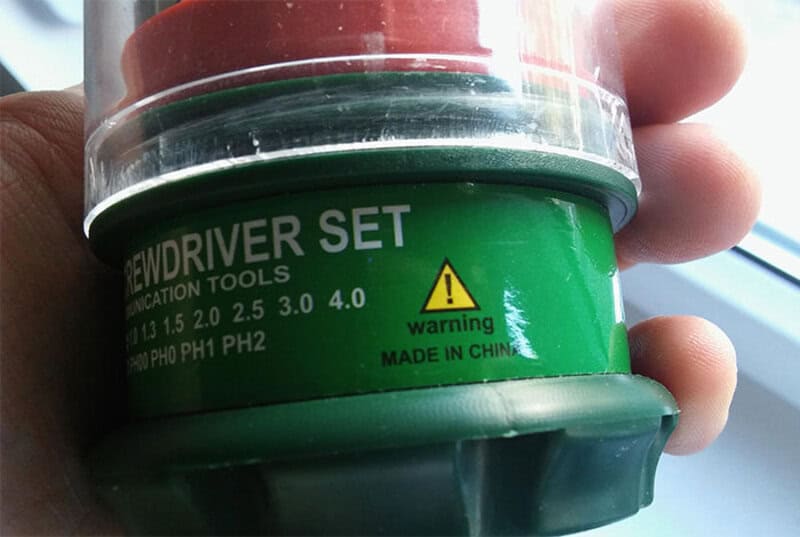Warning label on green container of screwdriver set, made in China.