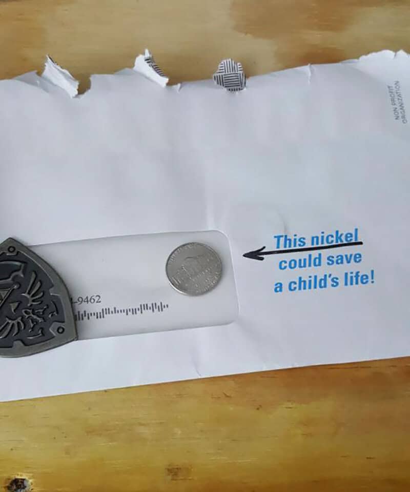 A paper with a coin and a nickel-shaped cutout with text saying 'This nickel could save a child's l.